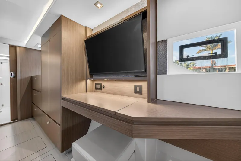  Yacht Photos Pics Modern interior of 2022 Leopard 45 yacht with TV and wooden cabinetry.