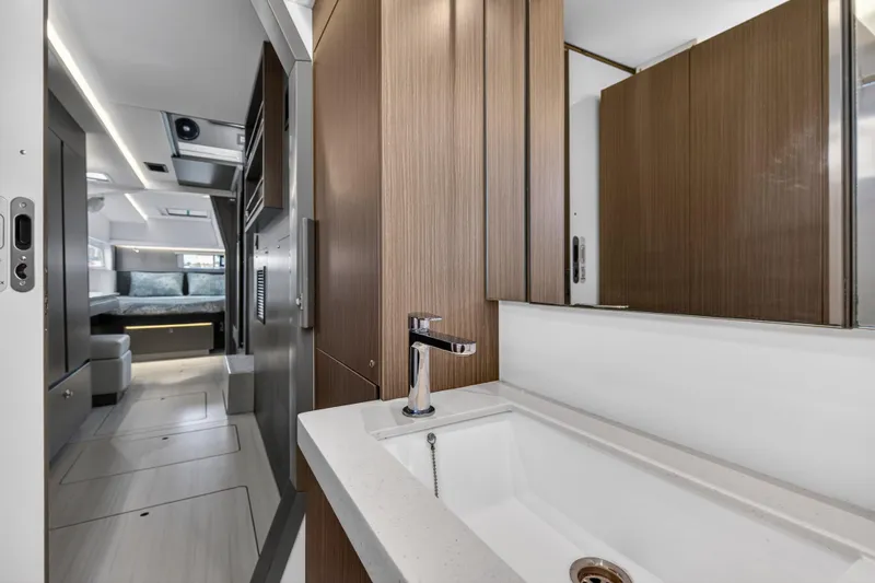  Yacht Photos Pics Modern bathroom interior in 2022 Leopard 45 yacht, featuring sleek wood cabinetry and a stylish sink.