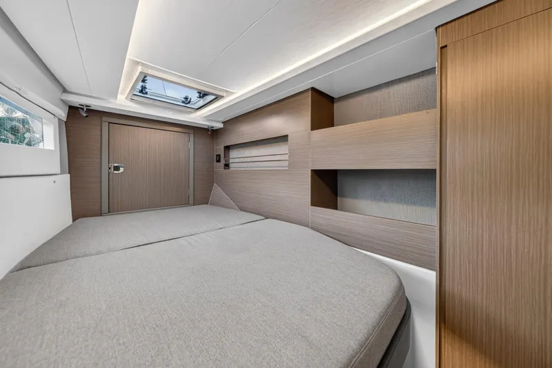  Yacht Photos Pics Modern interior of 2022 Leopard 45 yacht cabin with sleek wood finishes and skylight.