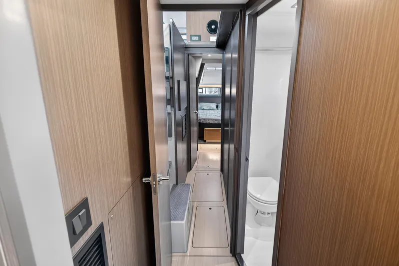  Yacht Photos Pics Interior hallway of 2022 Leopard 45 yacht, featuring wood paneling and modern design.