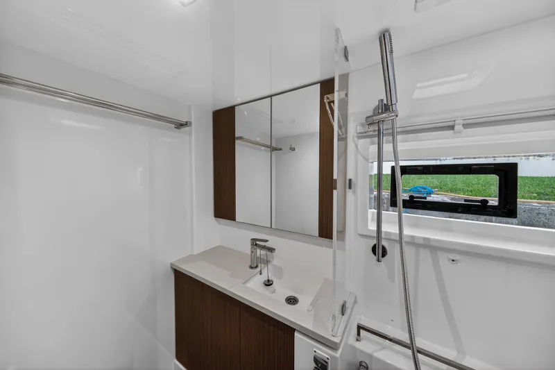  Yacht Photos Pics Modern bathroom interior on 2022 Leopard 45 yacht, featuring sleek fixtures and a window view.