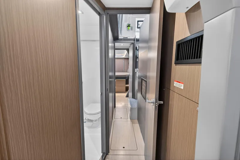  Yacht Photos Pics Interior view of 2022 Leopard 45 yacht, featuring hallway, bathroom, and cabin.