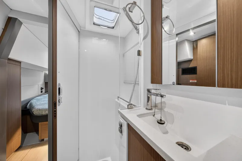  Yacht Photos Pics Modern bathroom interior on 2022 Leopard 45 yacht, featuring sleek design and wood accents.