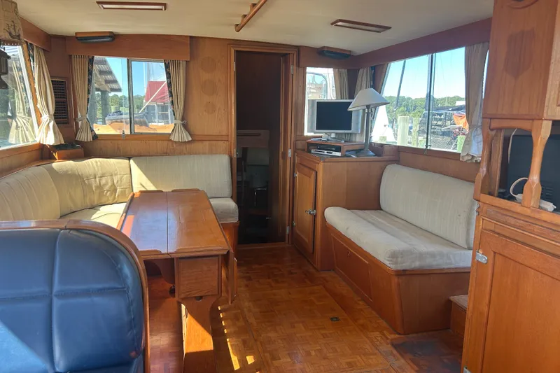 Metagene Yacht Photos Pics Interior of 1988 Grand Banks 42 Classic yacht with wooden furnishings and seating area.