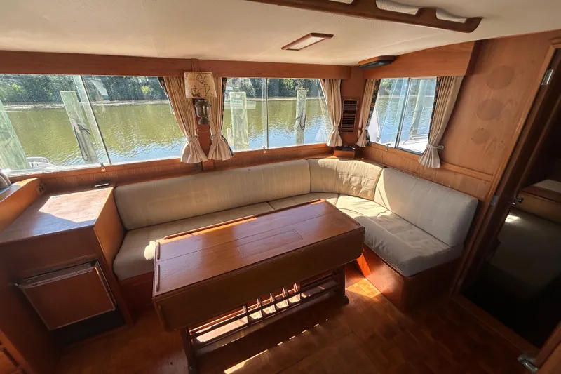 Metagene Yacht Photos Pics Interior of 1988 Grand Banks 42 Classic yacht with cozy seating and wooden table.