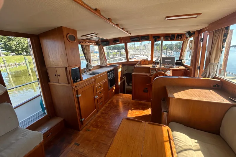 Metagene Yacht Photos Pics Interior of 1988 Grand Banks 42 Classic yacht with wooden furnishings and panoramic windows.