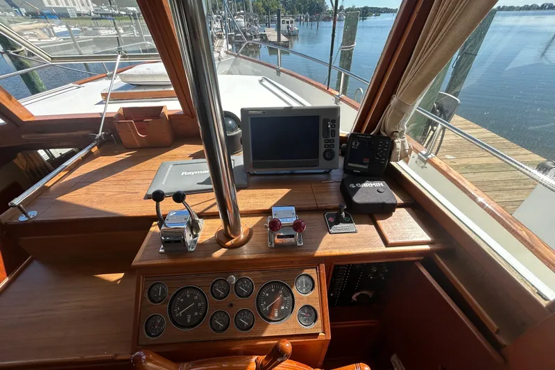 Metagene Yacht Photos Pics 1988 Grand Banks 42 Classic helm with navigation equipment and wooden dashboard.