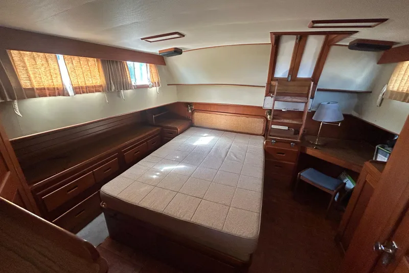 Metagene Yacht Photos Pics 1988 Grand Banks 42 Classic cabin interior with bed, wooden furniture, and natural light.