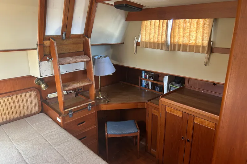 Metagene Yacht Photos Pics Cozy cabin interior of 1988 Grand Banks 42 Classic with wooden desk and bed.