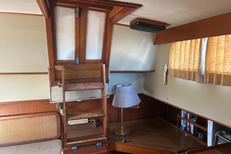 Metagene Yacht Photos Pics Interior of 1988 Grand Banks 42 Classic yacht with wooden ladder and desk area.