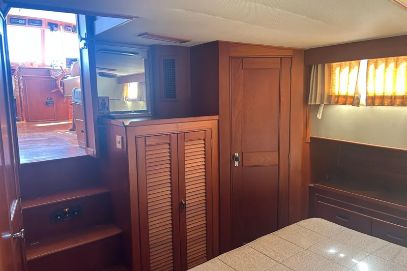 Metagene Yacht Photos Pics Interior of 1988 Grand Banks 42 Classic yacht, featuring wooden cabinetry and cozy cabin space.
