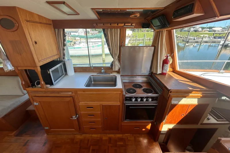 Metagene Yacht Photos Pics Interior of 1988 Grand Banks 42 Classic yacht kitchen with stove, sink, and microwave.