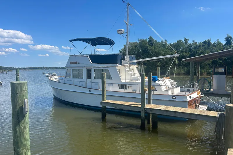 Metagene Yacht Photos Pics 1988 Grand Banks 42 Classic yacht docked at a marina under a clear blue sky.