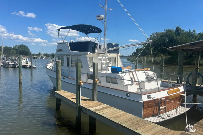 Metagene Yacht Photos Pics 1988 Grand Banks 42 Classic yacht docked at a marina under a clear blue sky.