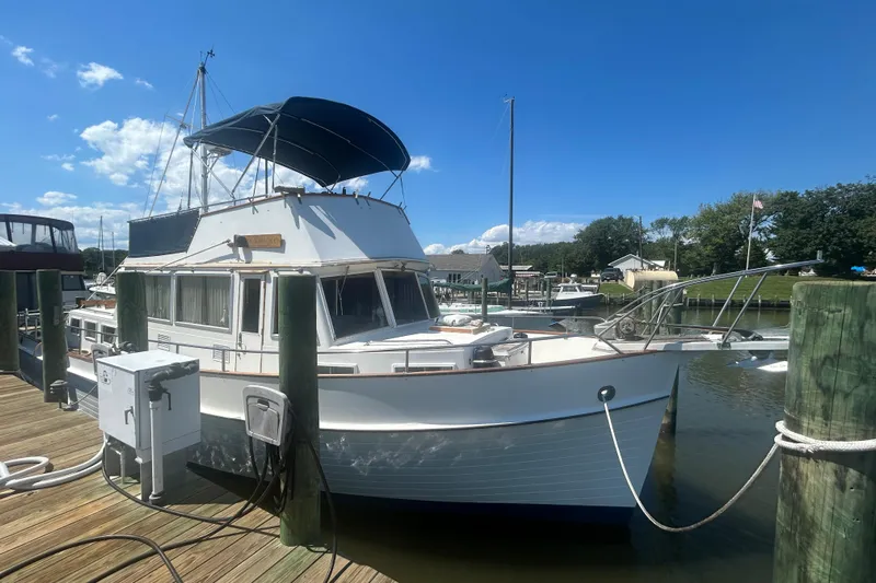 Metagene Yacht Photos Pics 1988 Grand Banks 42 Classic yacht docked at a marina under a clear blue sky.