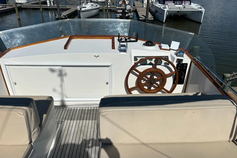 Metagene Yacht Photos Pics 1988 Grand Banks 42 Classic yacht helm with wooden wheel and marina view.