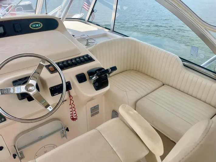  Yacht Photos Pics 2009 Grady-White 330 Explorer boat interior with steering wheel and seating.