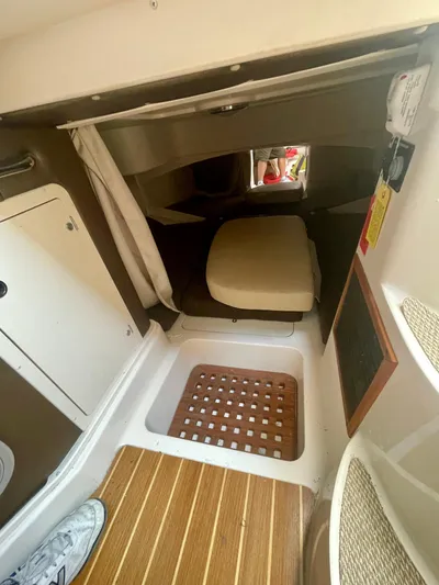  Yacht Photos Pics 2009 Grady-White 330 Explorer cabin interior with wooden flooring and seating area.