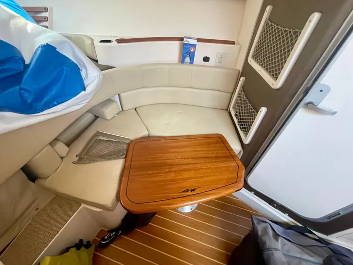  Yacht Photos Pics 2009 Grady-White 330 Explorer cabin interior with wooden table and seating area.