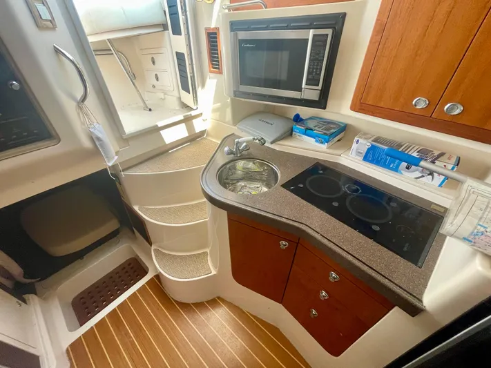  Yacht Photos Pics 2009 Grady-White 330 Explorer boat interior with kitchenette, microwave, and stairs.