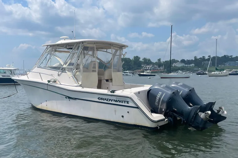  Yacht Photos Pics 2009 Grady-White 330 Explorer boat with twin outboard motors on a calm waterway.