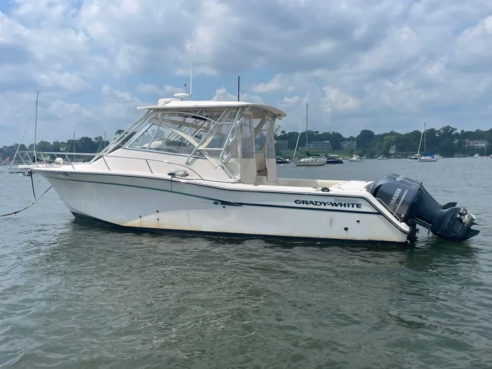  Yacht Photos Pics 2009 Grady-White 330 Explorer boat on calm water under cloudy sky.