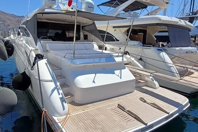  Yacht Photos Pics Luxury 2010 Princess V62 yacht docked at marina, showcasing sleek design and spacious deck.