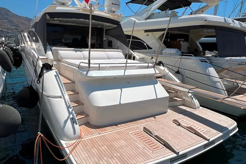  Yacht Photos Pics Luxury 2010 Princess V62 yacht docked, featuring spacious deck and elegant design.