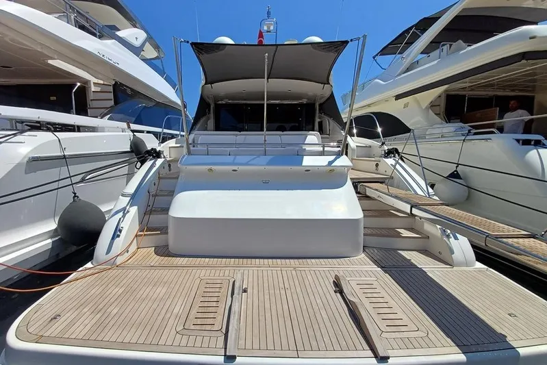  Yacht Photos Pics 2010 Princess V62 yacht docked between two other luxury boats.