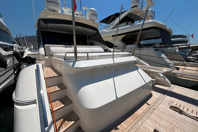  Yacht Photos Pics Luxury 2010 Princess V62 yacht docked, featuring sleek design and spacious deck area.