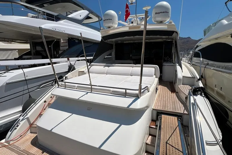  Yacht Photos Pics Luxurious 2010 Princess V62 yacht docked, featuring spacious sunbathing area and sleek design.