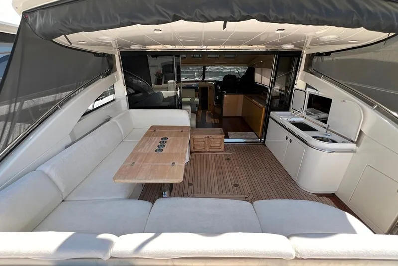  Yacht Photos Pics Luxurious 2010 Princess V62 yacht interior with spacious seating and kitchenette.