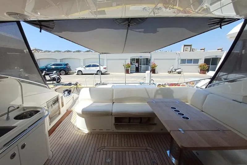  Yacht Photos Pics Luxurious 2010 Princess V62 yacht interior with seating and table, docked at marina.