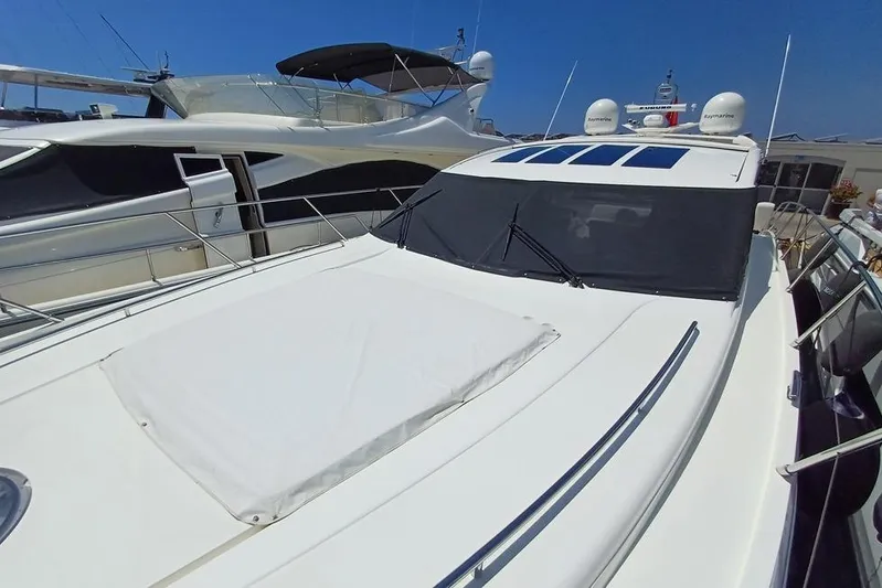  Yacht Photos Pics 2010 Princess V62 yacht with sleek design, docked under clear blue sky.