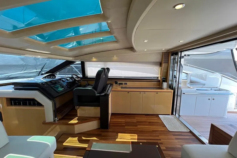  Yacht Photos Pics Luxurious interior of 2010 Princess V62 yacht with modern helm and wooden flooring.