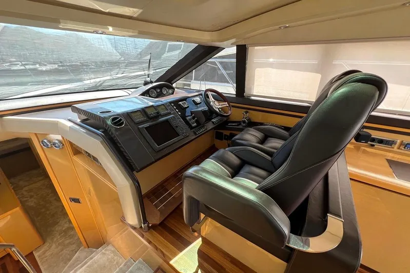  Yacht Photos Pics Luxurious helm of 2010 Princess V62 yacht with leather seating and advanced controls.