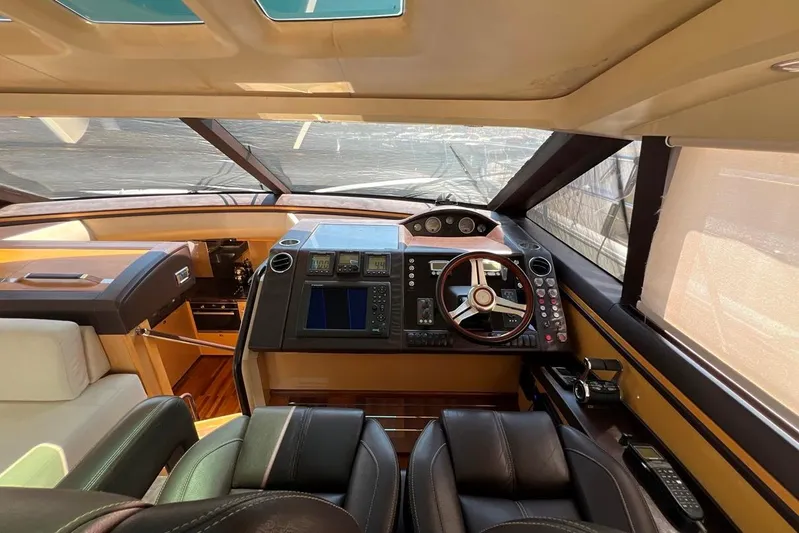  Yacht Photos Pics Interior of 2010 Princess V62 yacht cockpit with modern navigation controls and leather seating.