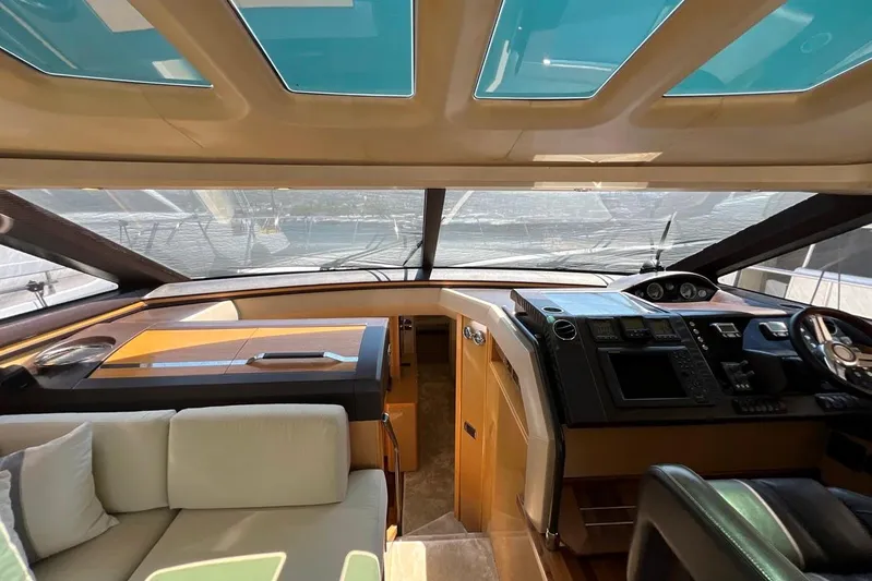  Yacht Photos Pics Luxurious interior of 2010 Princess V62 yacht with modern helm and seating area.