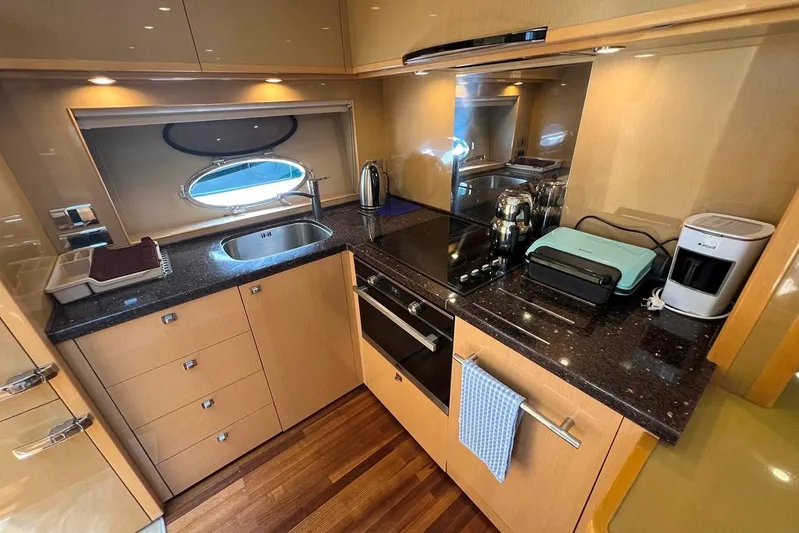  Yacht Photos Pics Luxurious 2010 Princess V62 yacht kitchen with modern appliances and sleek design.