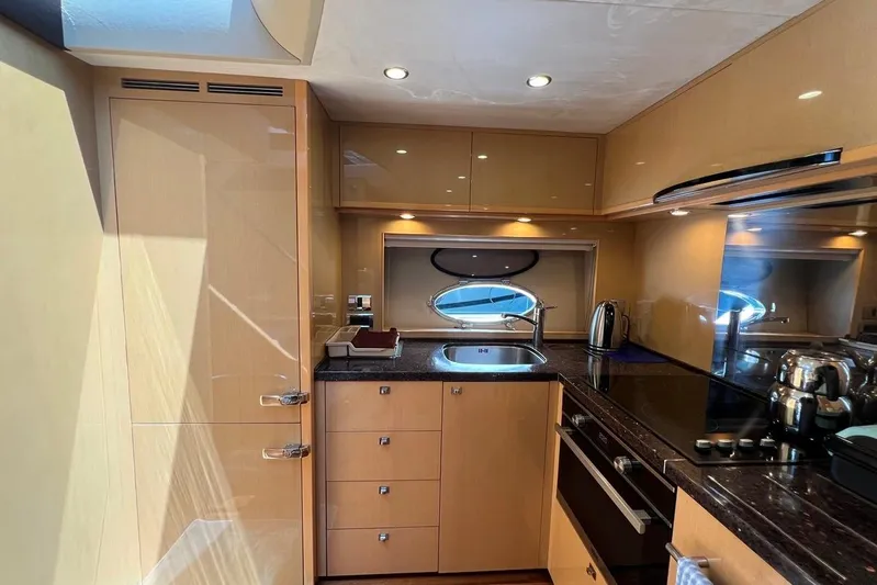  Yacht Photos Pics Luxurious kitchen interior of 2010 Princess V62 yacht with modern appliances and sleek design.