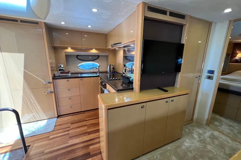  Yacht Photos Pics Luxurious 2010 Princess V62 yacht interior with modern kitchen and entertainment area.