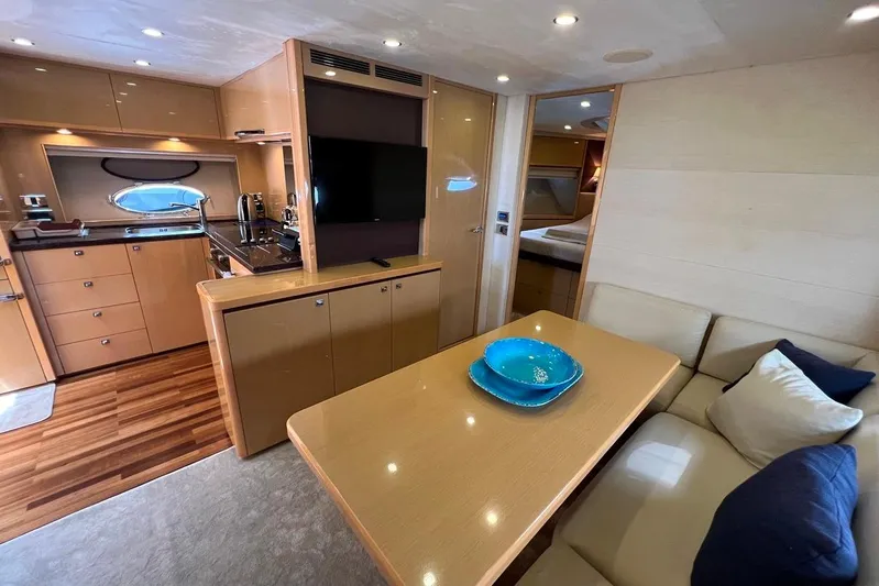  Yacht Photos Pics Luxurious interior of 2010 Princess V62 yacht with modern kitchen and cozy seating area.