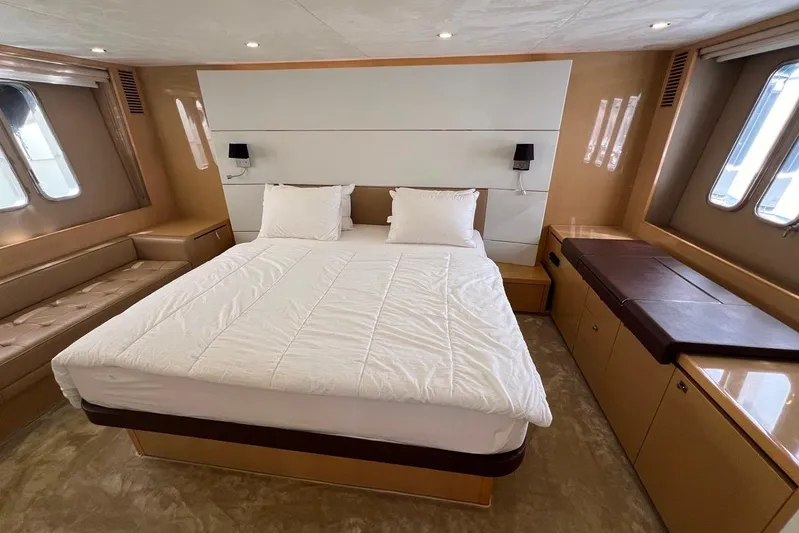  Yacht Photos Pics Luxurious bedroom interior of 2010 Princess V62 yacht with elegant furnishings and natural light.