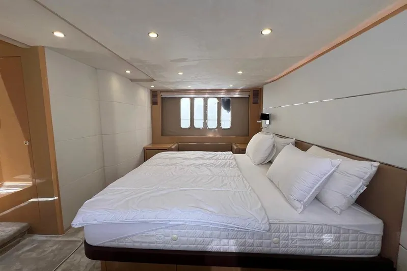  Yacht Photos Pics Luxurious bedroom interior of 2010 Princess V62 yacht with elegant bedding and modern lighting.