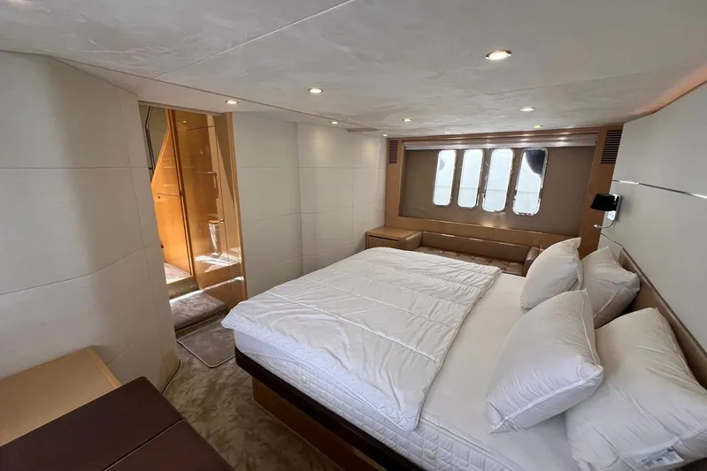  Yacht Photos Pics Luxurious bedroom interior of 2010 Princess V62 yacht with modern design and cozy bedding.