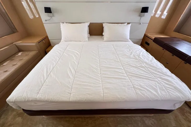  Yacht Photos Pics Luxurious bedroom interior of 2010 Princess V62 yacht with elegant bedding and modern design.