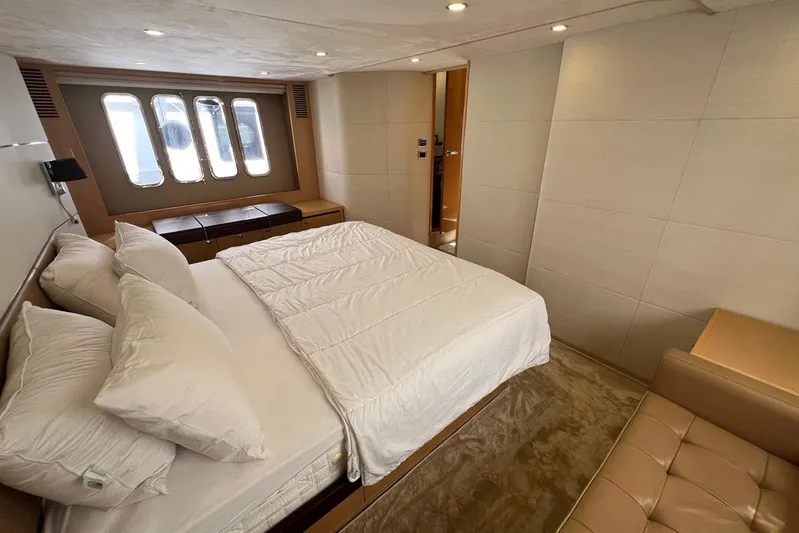  Yacht Photos Pics Luxurious bedroom interior on a 2010 Princess V62 yacht, featuring a comfortable bed and modern design.