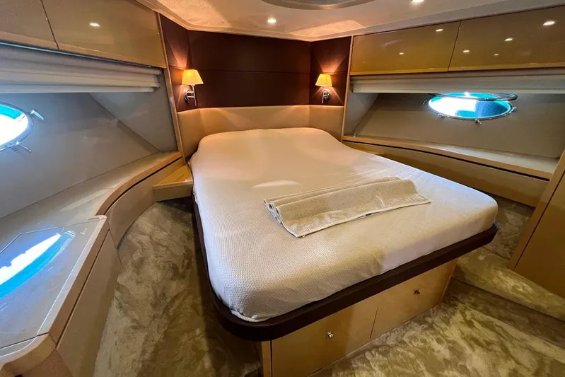  Yacht Photos Pics Luxurious 2010 Princess V62 yacht bedroom with elegant lighting and plush bedding.