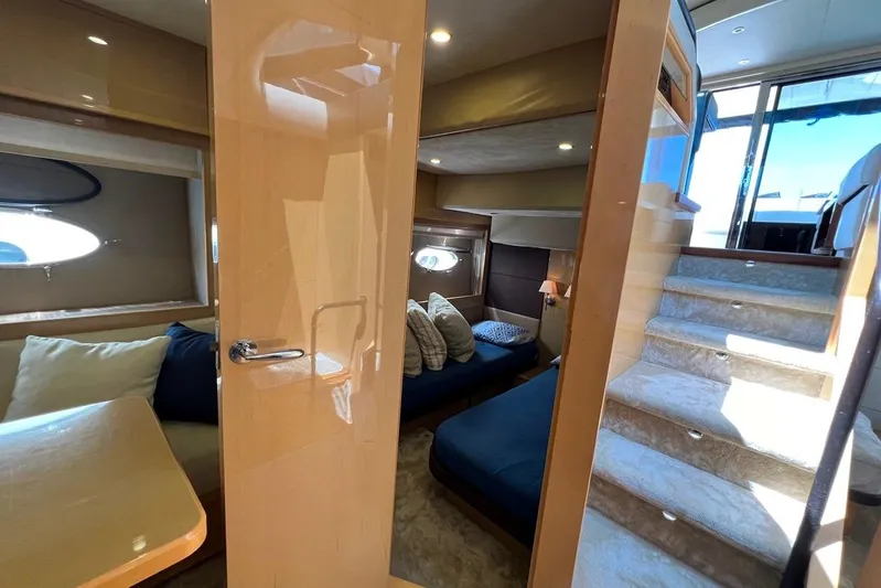  Yacht Photos Pics Luxurious interior of 2010 Princess V62 yacht with cozy seating and elegant staircase.