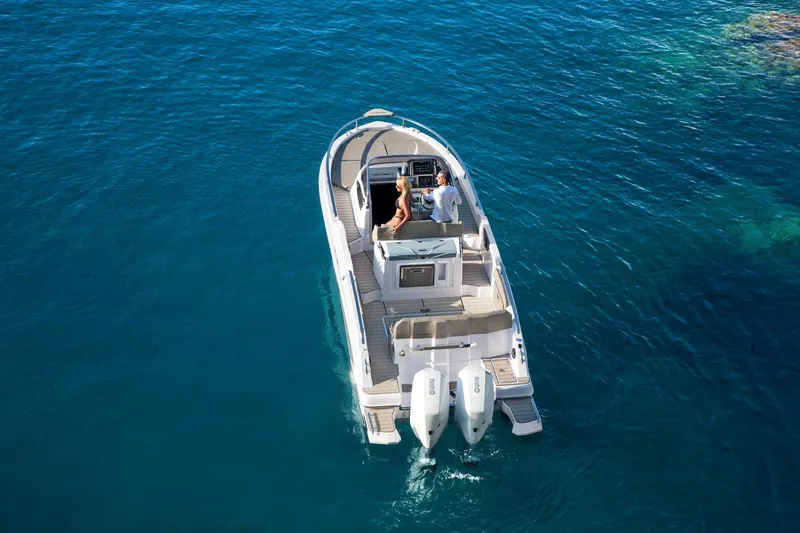  Yacht Photos Pics 2025 Ranieri NEXT 285 XL boat cruising on clear blue water.